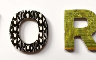 The word 'work' in 3D with each letter a different fabric.